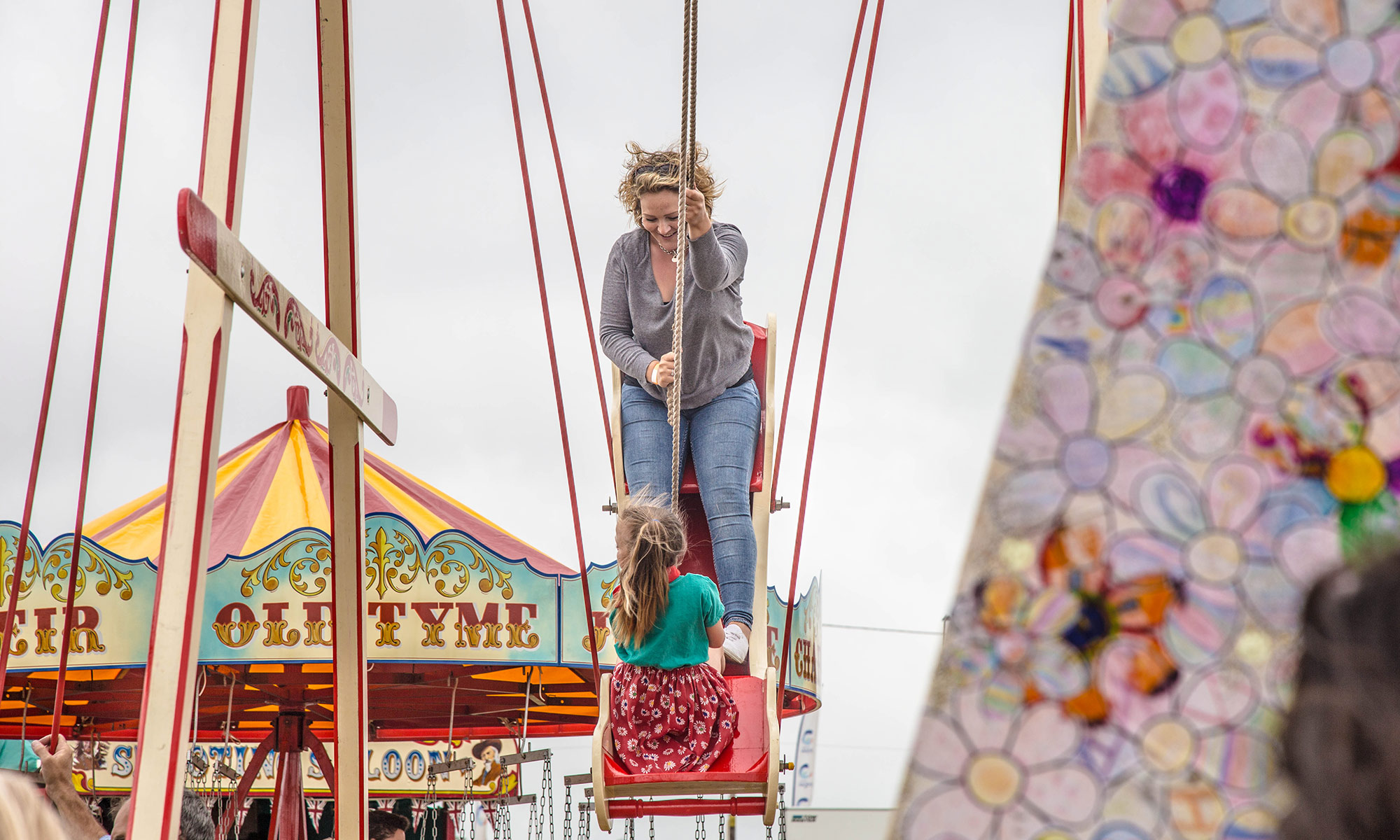 mother and child on a vintage fairground ride