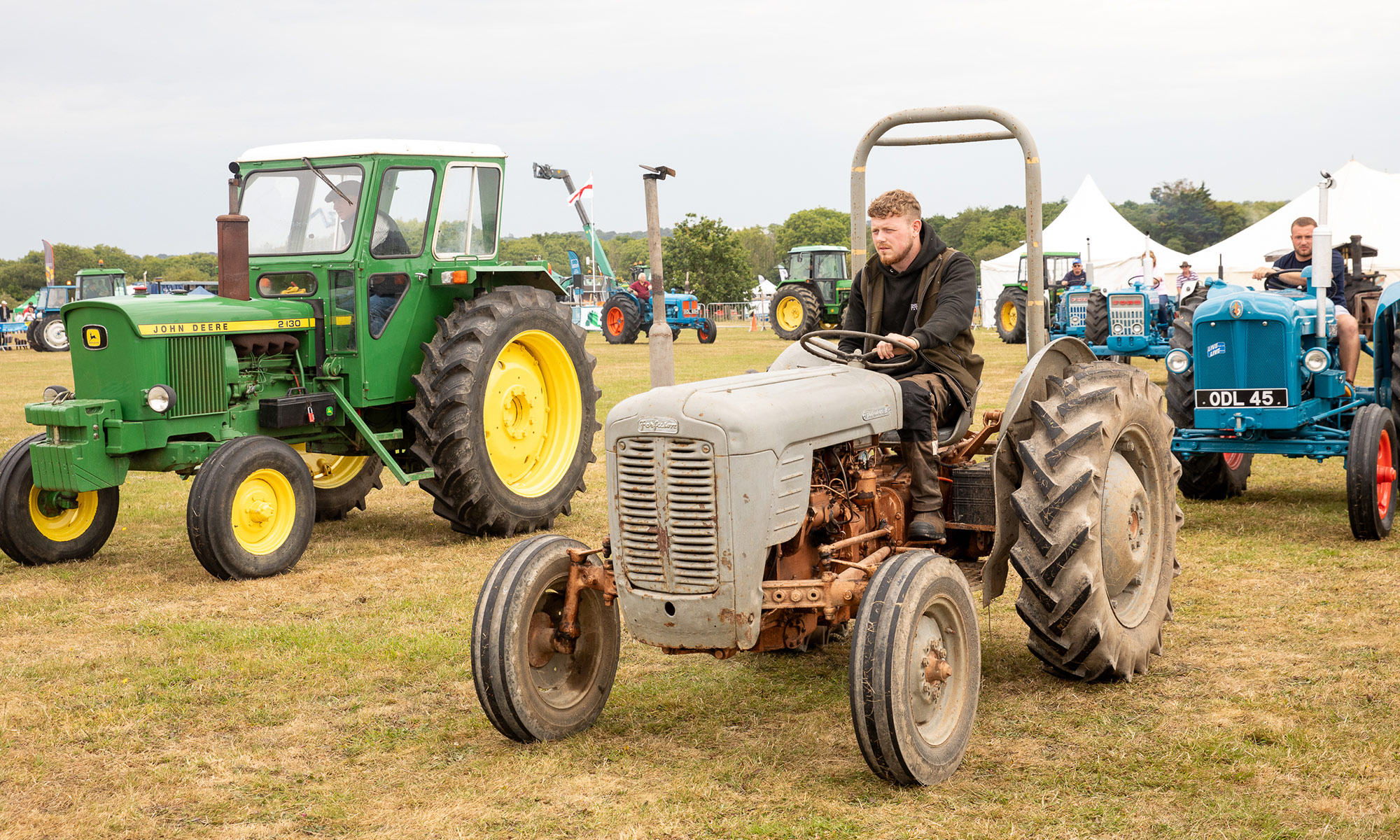 man driving a vintage tractor